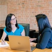 Two office workers at a desk.
