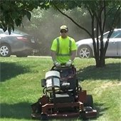 Summer Worker Mowing Lawn