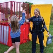 Police Officer with Child at National Night Out Event