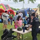 Police Officer with Child at National Night Out Event