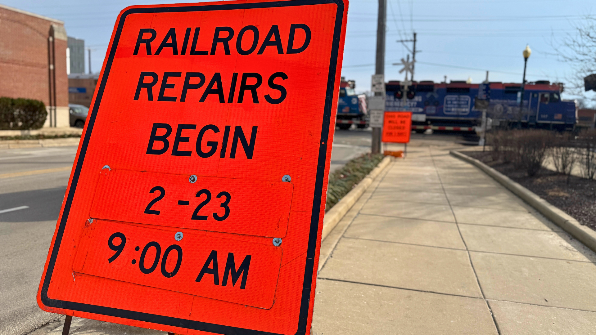 Sign next to a street which says "Railroad Repairs 2-23 starting at 9 a.m."